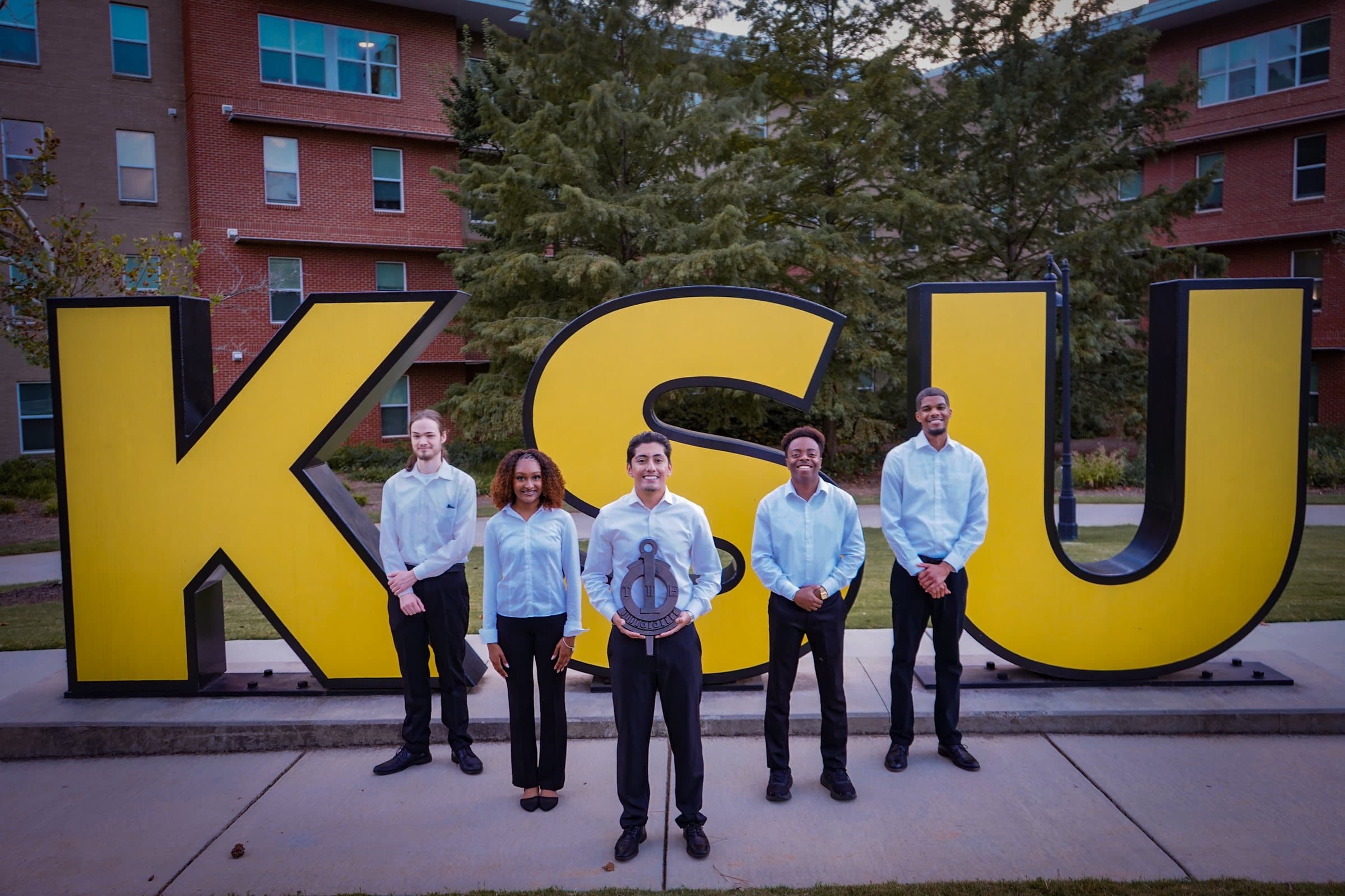 The Upsilon Pi Epsilon executive board on the stairwell in the Kennesaw State University computing building.
